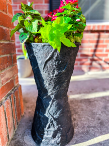 DIY cement planter on a budget with trailing plant, made from a towel and concrete mix